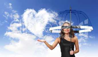 Pretty young woman with umbrella and hearts