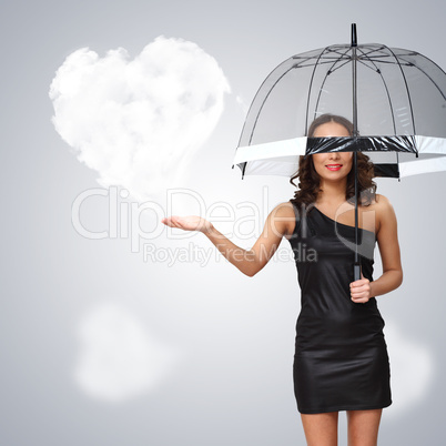 Pretty young woman with umbrella and hearts