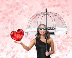 Pretty young woman with umbrella and hearts