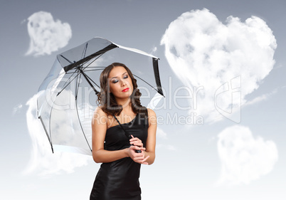 Pretty young woman with umbrella and hearts