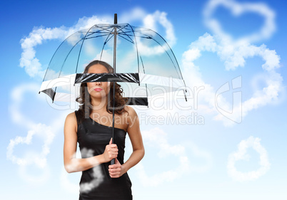 Pretty young woman with umbrella and hearts