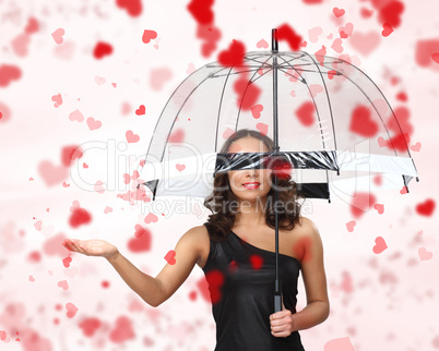 Pretty woman under umbrella with petals around her