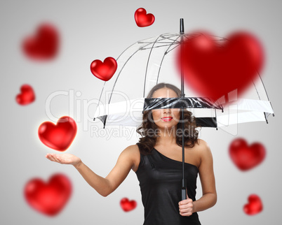 Pretty young woman with umbrella and hearts