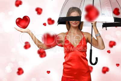 Pretty young woman with umbrella and hearts