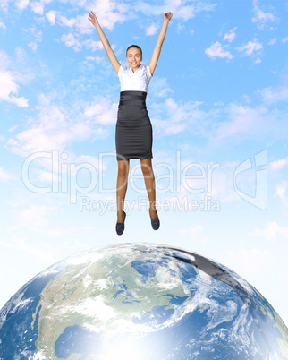 Young woman jumping and our planet earth