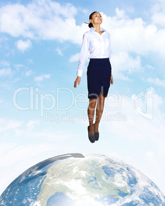 Young woman jumping and our planet earth