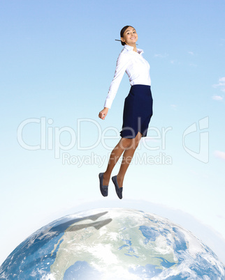 Young woman jumping and our planet earth