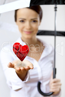 Woman with a red heart in her hand