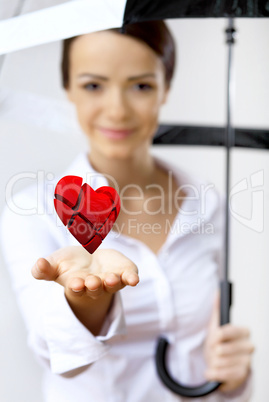 Woman with a red heart in her hand