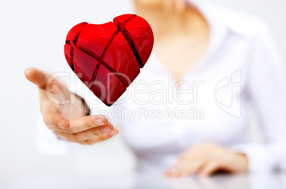Woman with a red heart in her hand