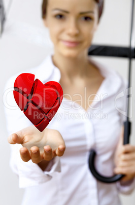 Woman with a red heart in her hand