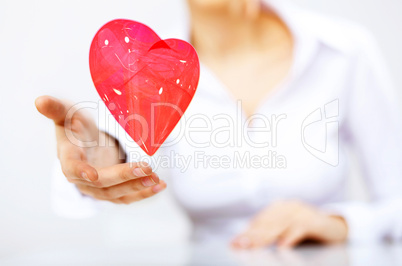 Woman with a red heart in her hand