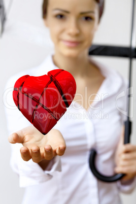 Woman with a red heart in her hand