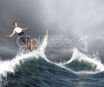 Businesswoman surfing on the sea waves