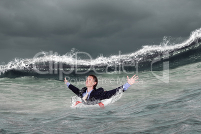 Businessman surfing on the sea waves