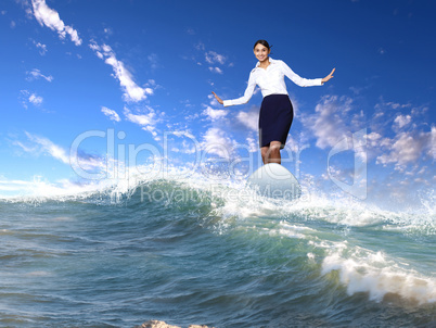 Businesswoman surfing on the sea waves