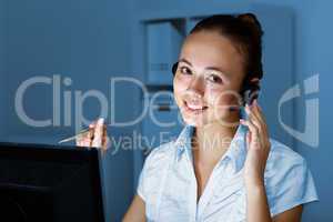 Young woman in business wear and headset