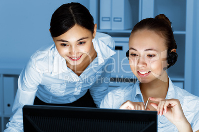 Young woman in business wear and headset