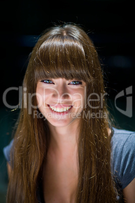 A beautiful girl with long hair coquettishly smiling