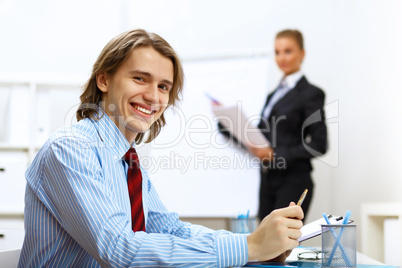 Young businessman at work in office