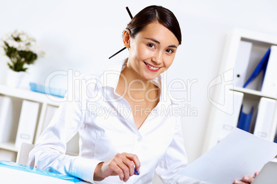 Young woman in business wear in office