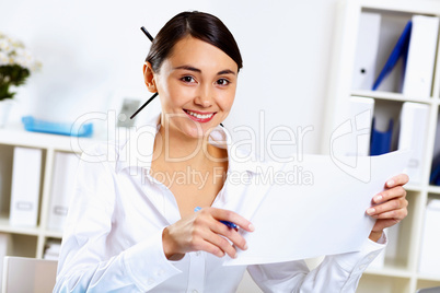 Young woman in business wear in office