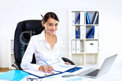 Young woman in business wear in office