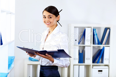 Young woman in business wear in office