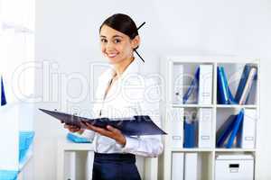 Young woman in business wear in office