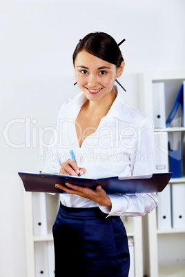 Young woman in business wear in office