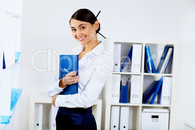 Young woman in business wear in office