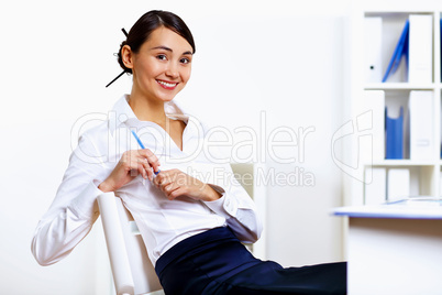 Young woman in business wear in office