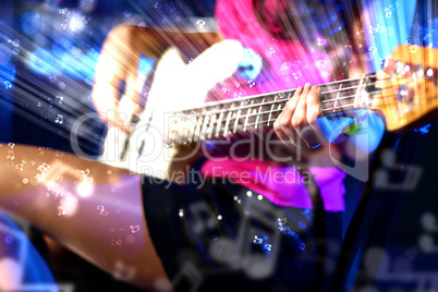 Young guitar player performing in night club