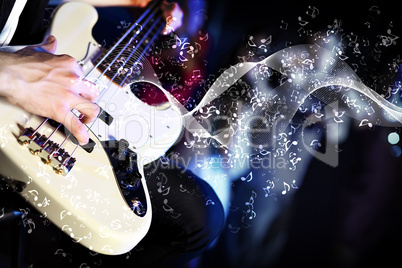 Young guitar player performing in night club