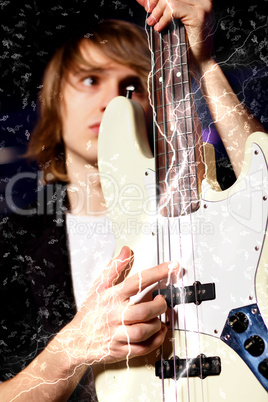 Young guitar player performing in night club