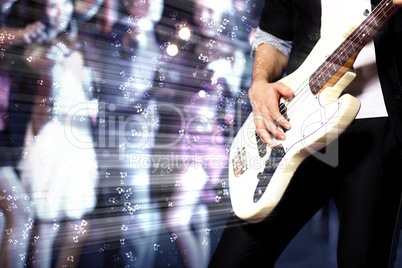 Young guitar player performing in night club