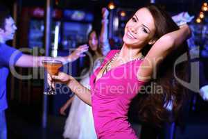 Young woman having fun at nightclub disco