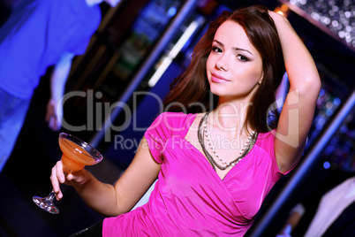 Young woman having fun at nightclub disco