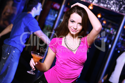 Young woman having fun at nightclub disco