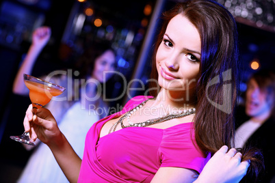 Young woman having fun at nightclub disco