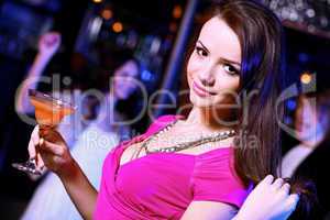 Young woman having fun at nightclub disco