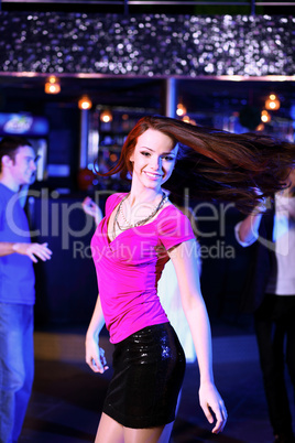 Young woman having fun at nightclub disco