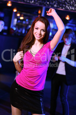 Young woman having fun at nightclub disco