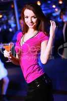 Young woman having fun at nightclub disco