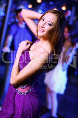 Young woman having fun at nightclub disco