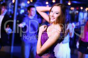 Young woman having fun at nightclub disco
