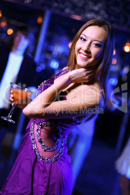 Young woman having fun at nightclub disco