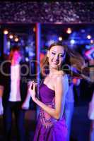 Young woman having fun at nightclub disco