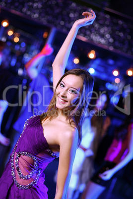 Young woman having fun at nightclub disco