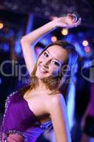 Young woman having fun at nightclub disco